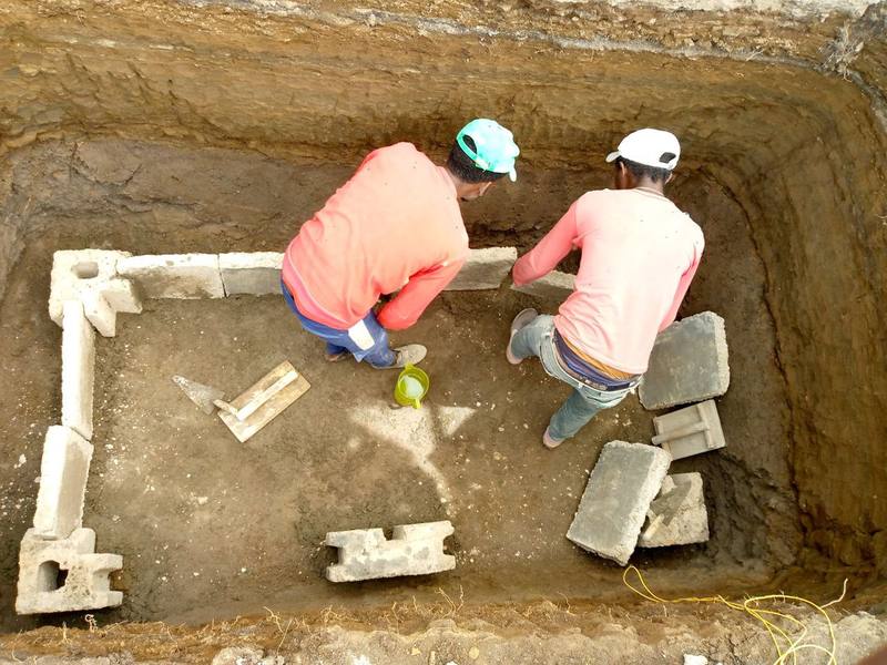 Artisans assembling interlocking pit-lining panels