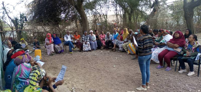 A community sanitation promotion meeting